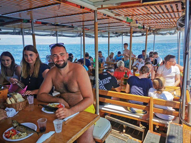 People enjoying lunch on a boat tour for large groups from Rijeka